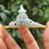 a person holding a small statue