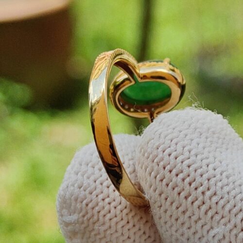 a finger in a glove holding a ring