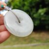 a hand holding a white round object