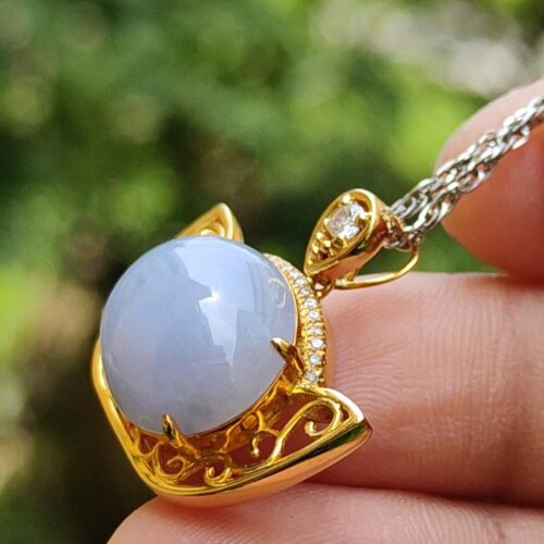 a hand holding a necklace