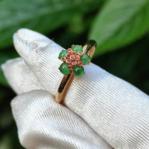 a hand wearing a glove with a ring on it