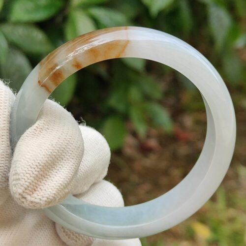 a hand holding a circular object