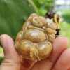 a hand holding a small stone pendant