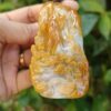a hand holding a carved stone