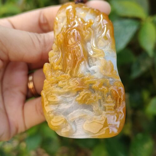 a hand holding a carved stone