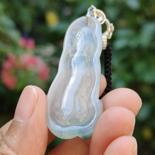 a hand holding a blue and white necklace