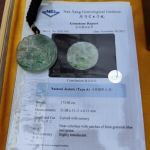 a jade pendant on a piece of paper