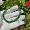 a hand wearing a glove with a bracelet on it