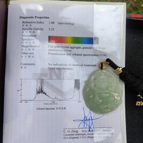 a book with a jade pendant