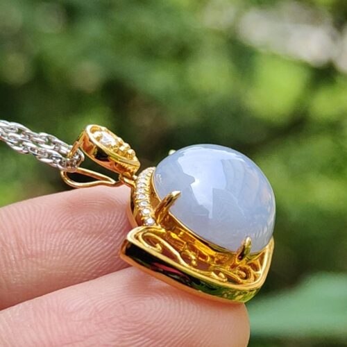 a hand holding a necklace