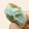 a hand holding a jade ring