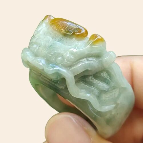 a hand holding a jade ring