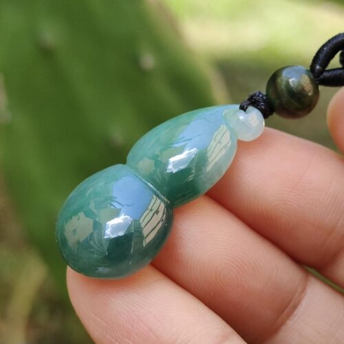 a hand holding a necklace