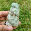 a hand holding a jade object