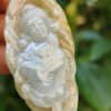 a hand holding a white stone