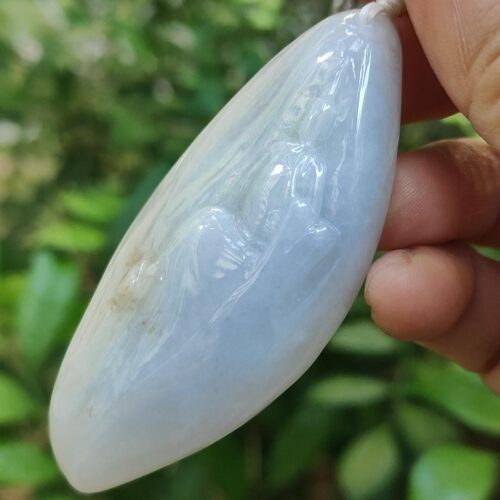 a hand holding a white object