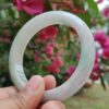 a hand holding a white circular ring