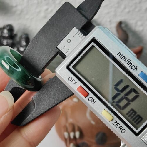 a hand holding a small digital device