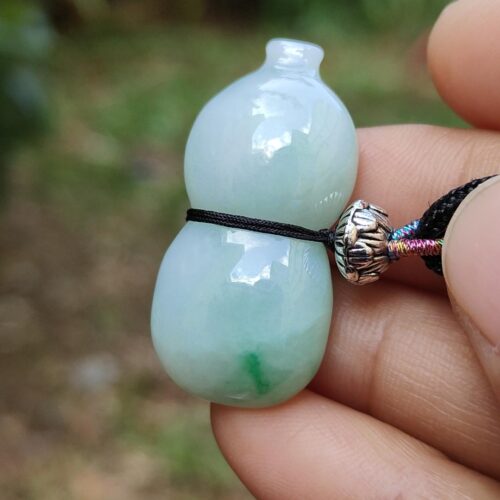 a hand holding a bead