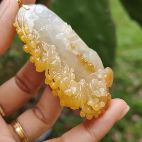 a hand holding a piece of jewelry