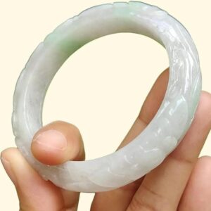 a hand holding a white circular object