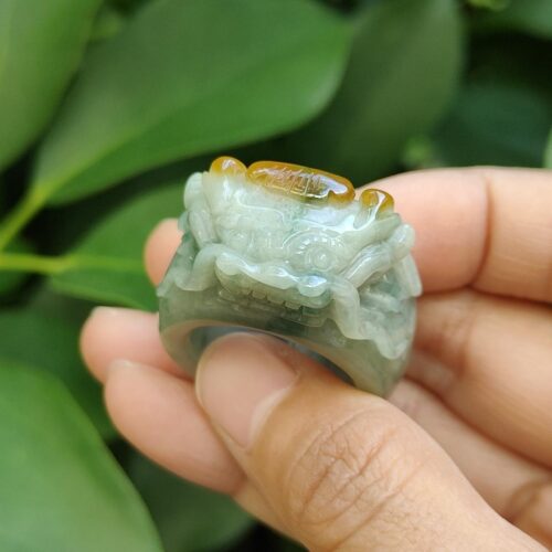 a hand holding a jade ring