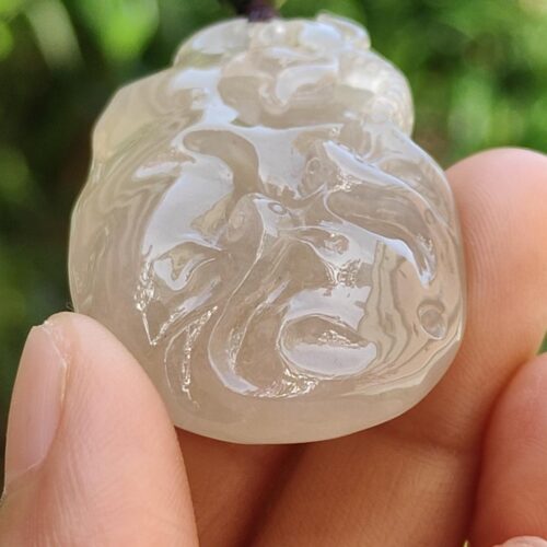 a hand holding a white stone