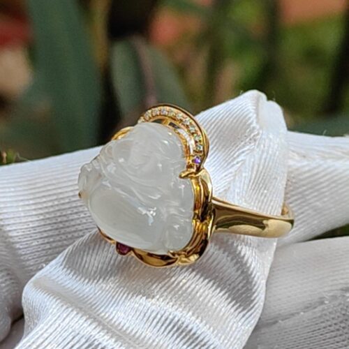 a gold ring with a white stone on it