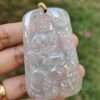 a hand holding a jade pendant