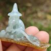 a person holding a small stone statue