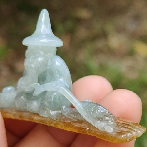 a person holding a small stone statue
