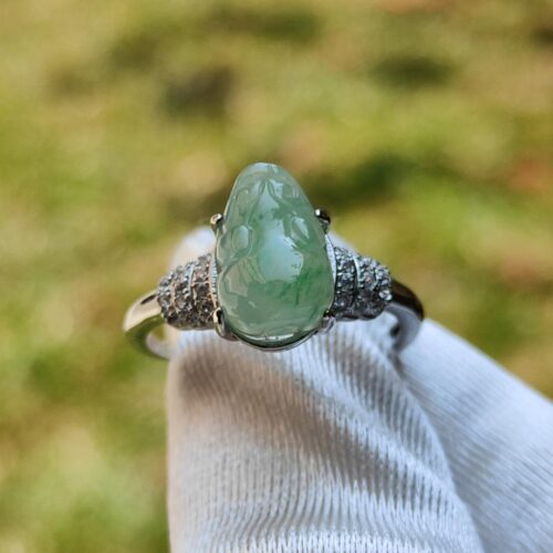 a ring with a green stone on it