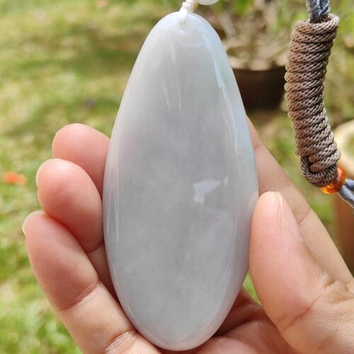 a hand holding a white stone