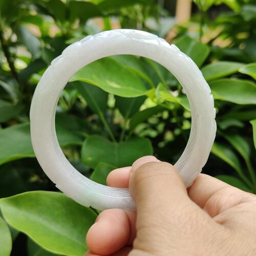 a hand holding a white circular object