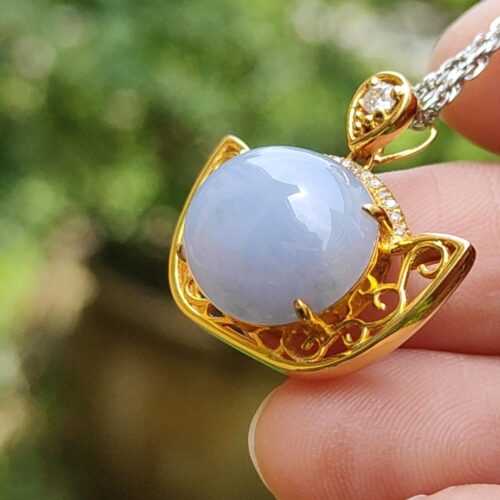 a hand holding a necklace