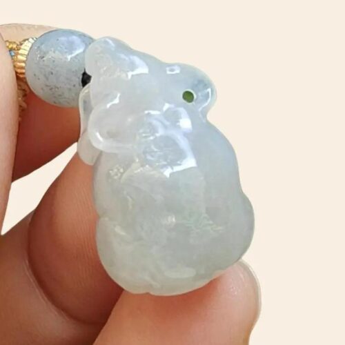 a hand holding a jade bead