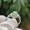 a ring with a green stone on it