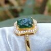 a ring with a green stone in it