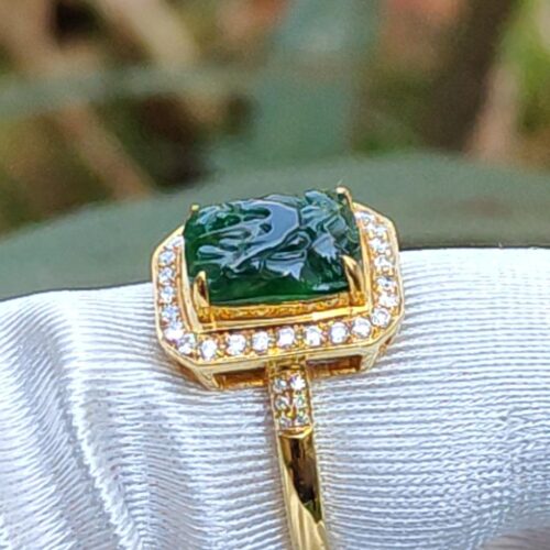 a ring with a green stone in it