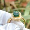a ring with a green stone in it