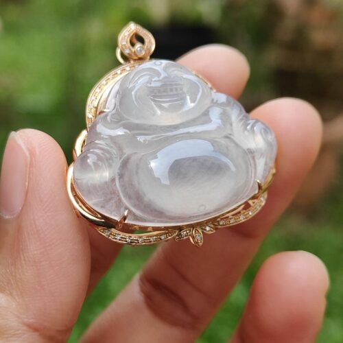 a hand holding a jade pendant