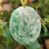 a jade pendant with a rose on it
