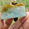 Una mano sosteniendo un colgante de jade.