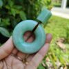 a hand holding a green round object