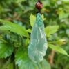 a green jade pendant from a string