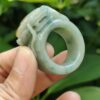 a hand holding a jade ring