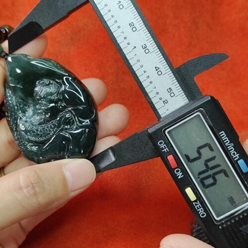 a person measuring a piece of jewelry