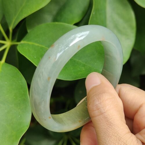 a hand holding a bracelet