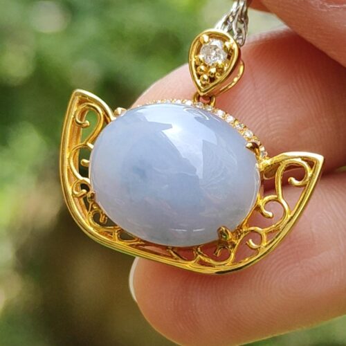 a hand holding a necklace