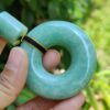 a hand holding a green round object
